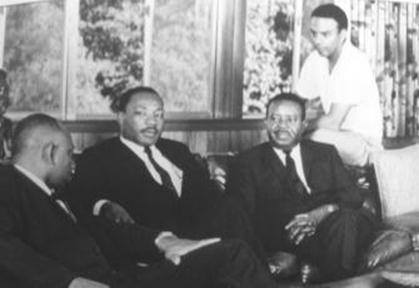 Herman J. Russell, Dr. Martin Luther King Jr., Dr. Ralph Abernathy, Andrew Young, photographed in Russell’s living room